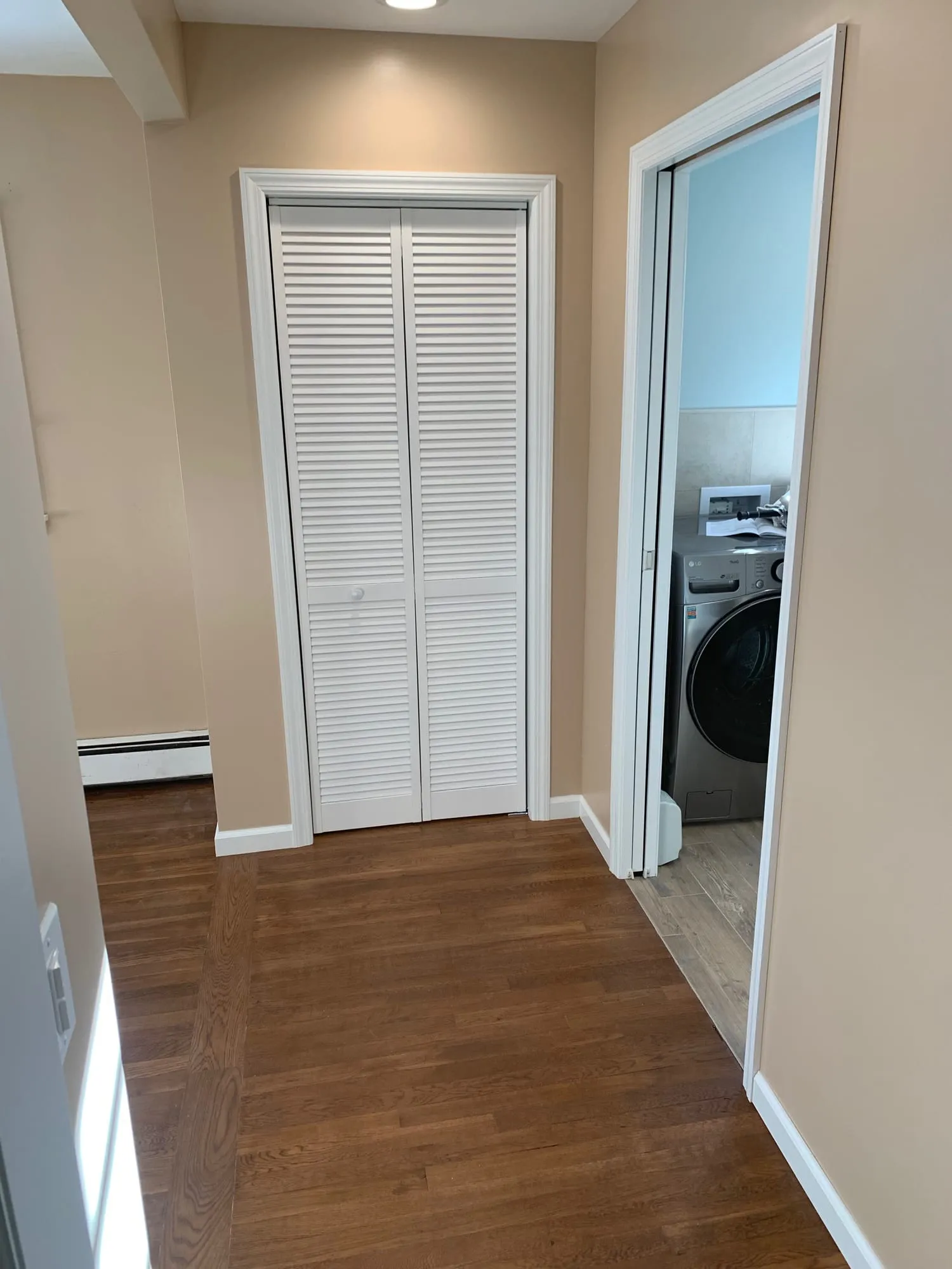 Laundry closet and bathroom entry off the hallway