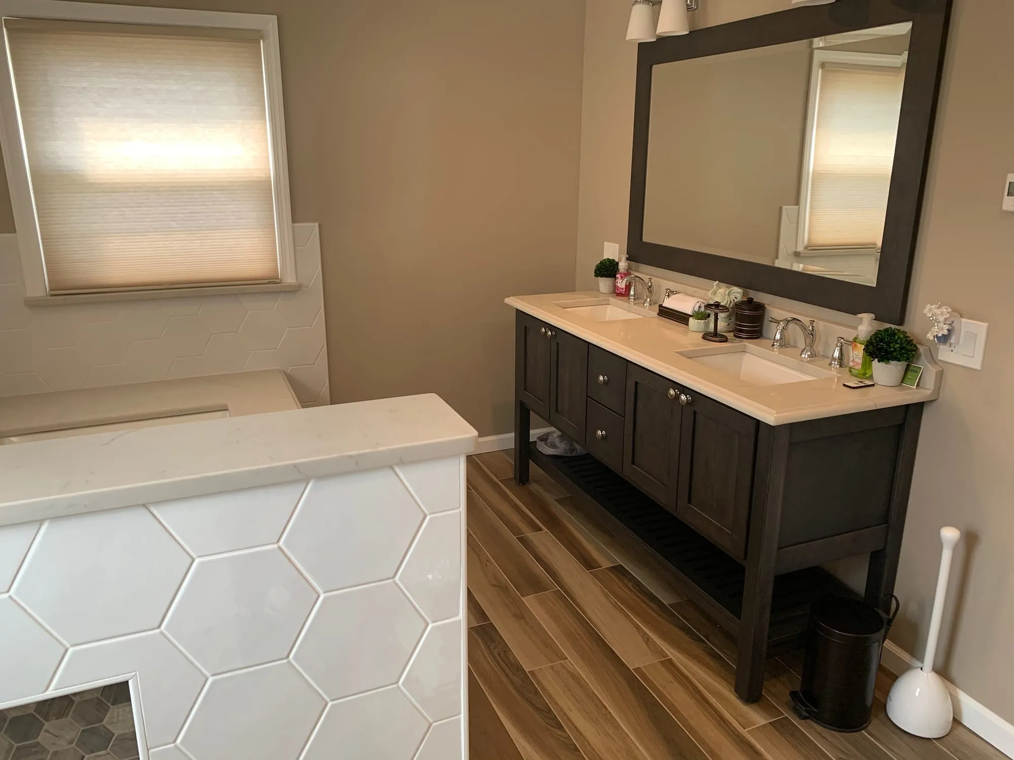 Bathroom with a double vanity beside the tiled tub surround