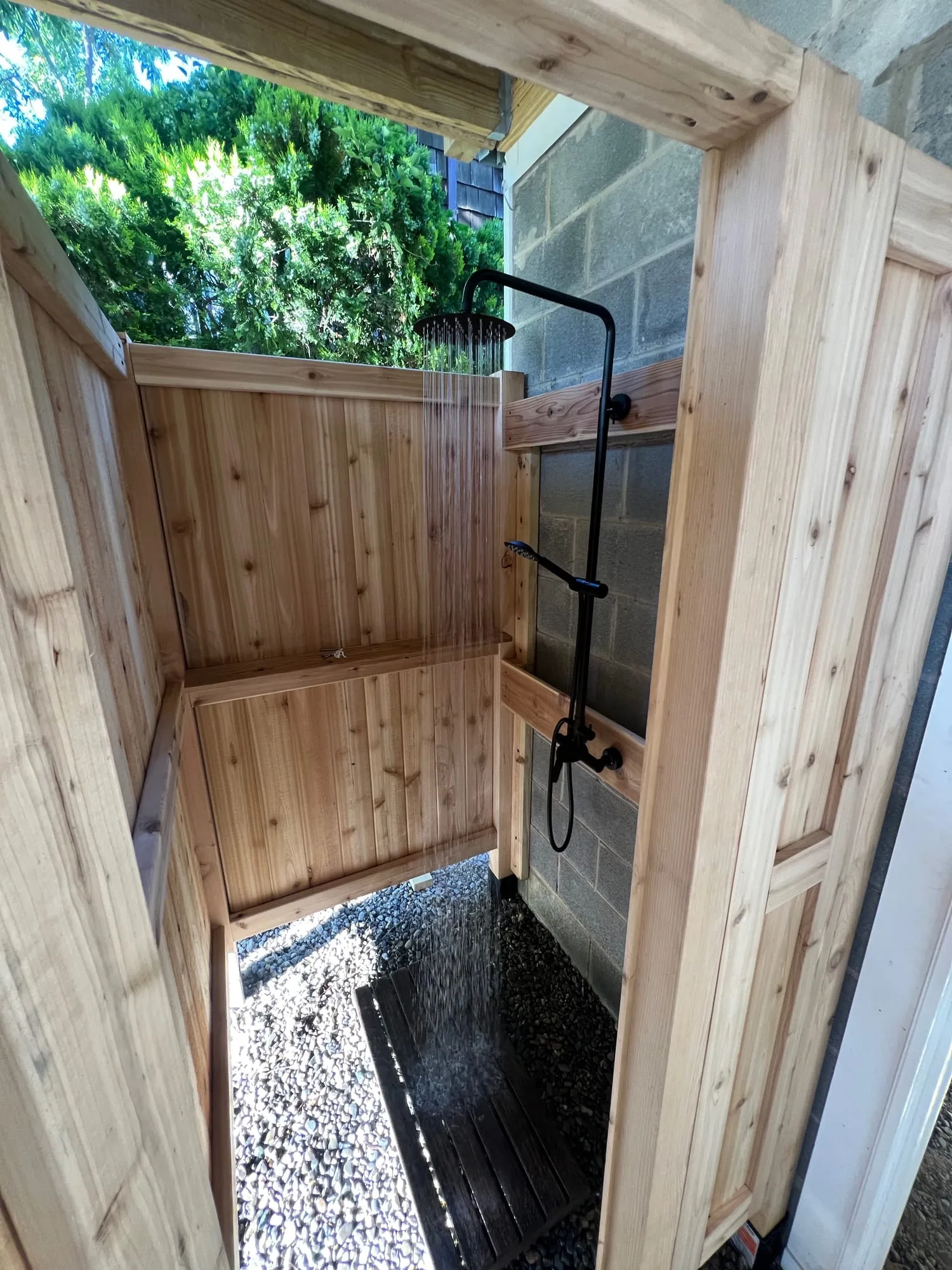 Cedar shower walls and matte black shower column