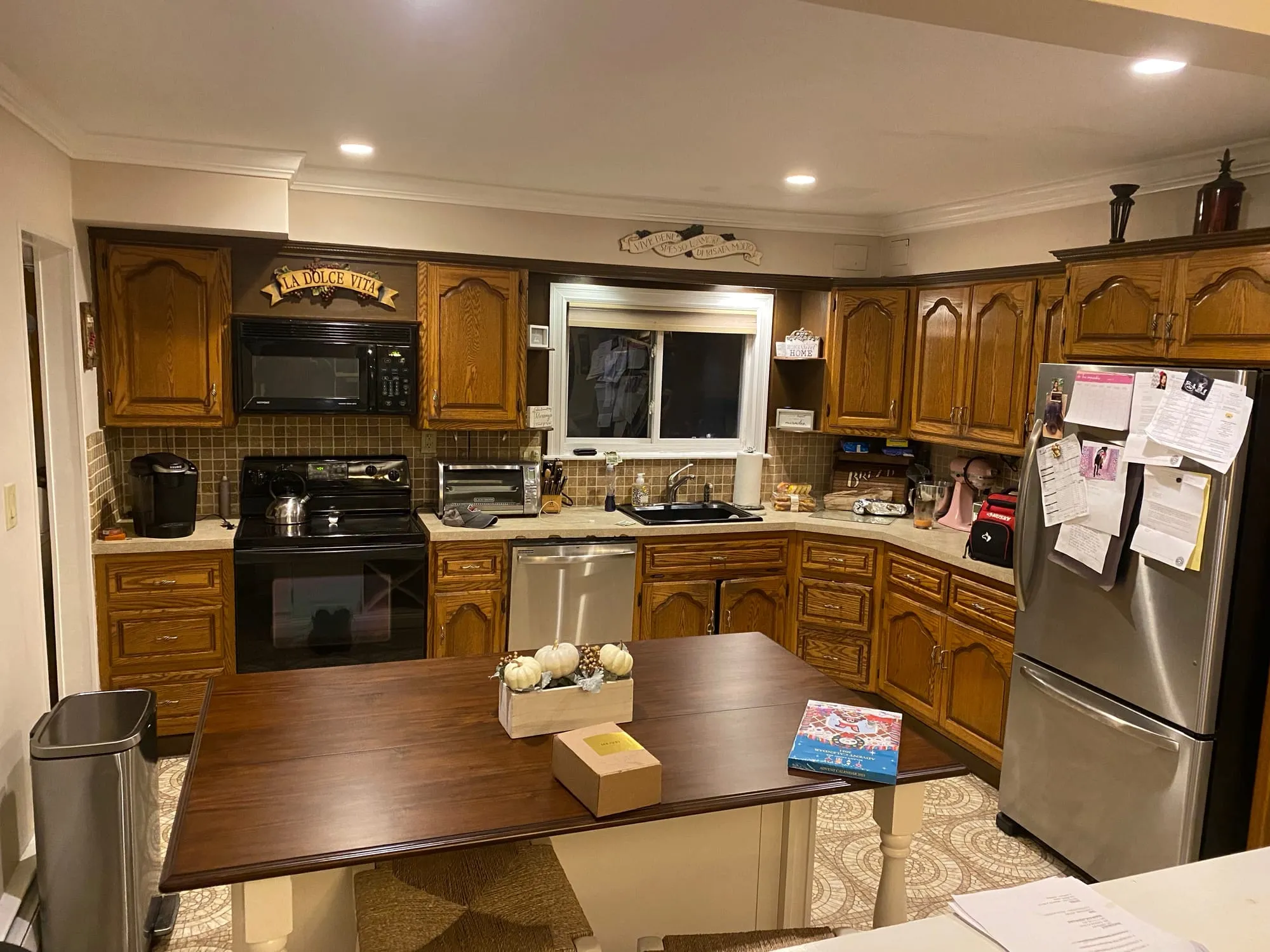 Dix Hills kitchen before renovation, with oak cabinets and black appliances
