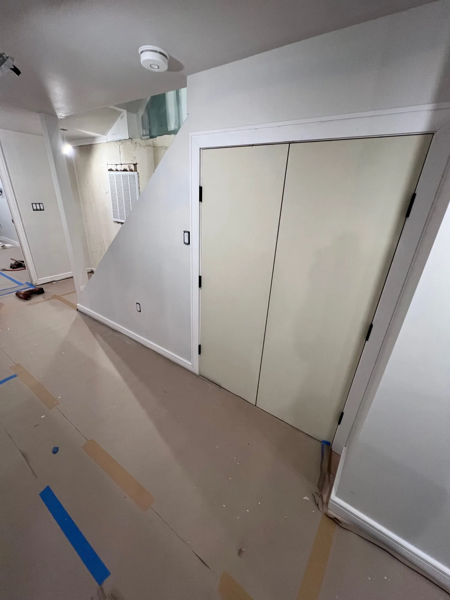 Closet and hallway finished, with floor protection still down