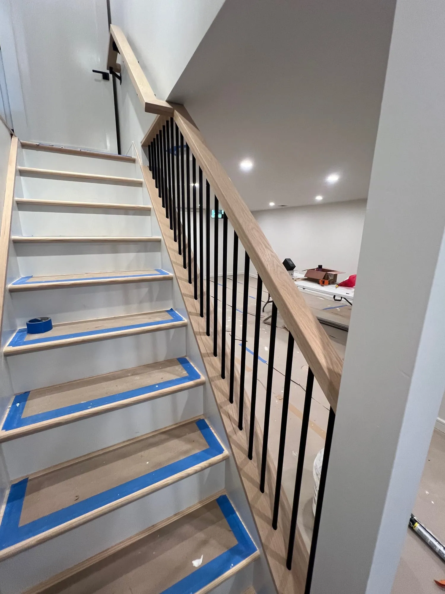 Looking up the new staircase during finishing, with tread protection in place