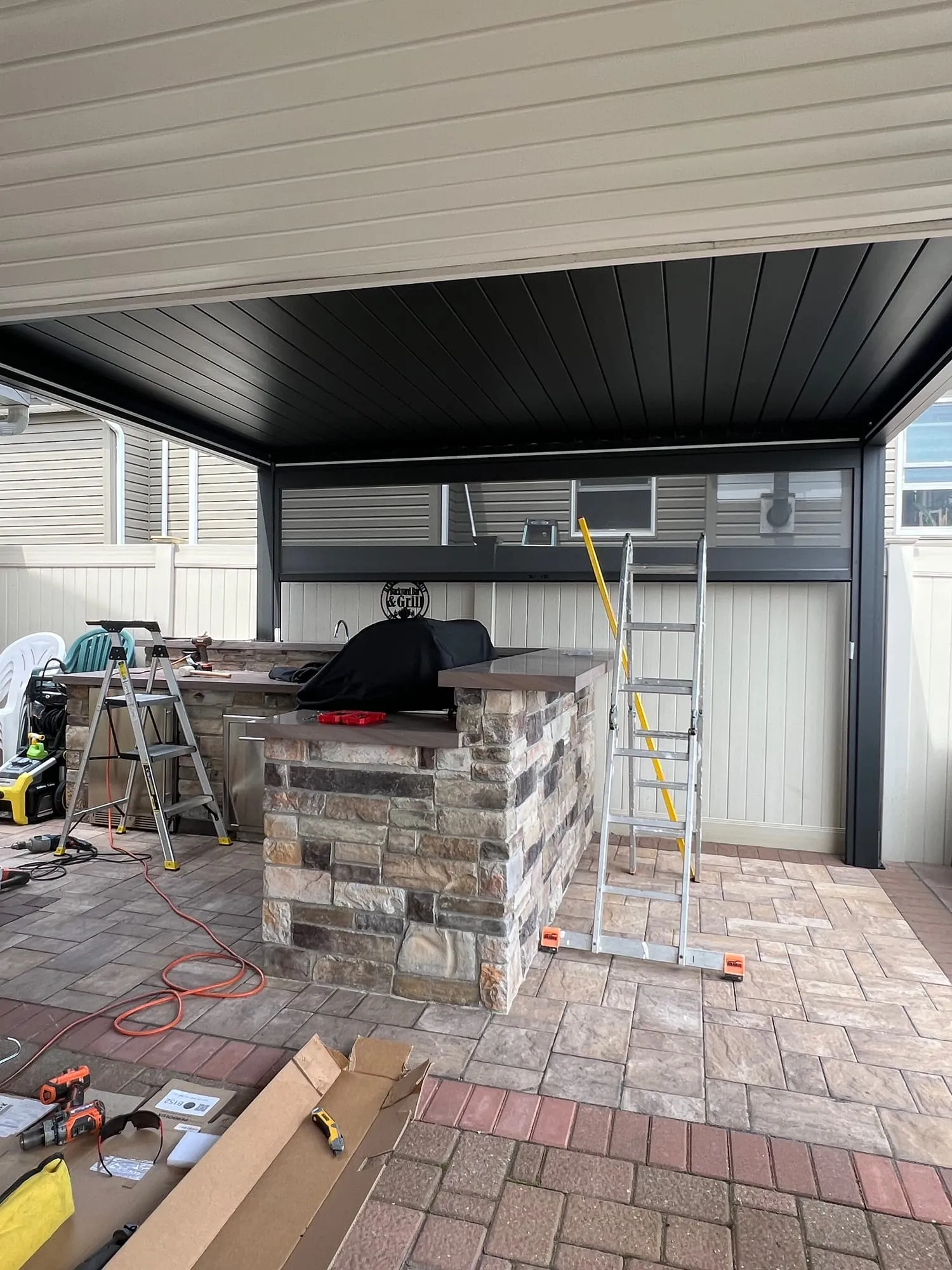 Pergola roof installed over the outdoor kitchen during installation