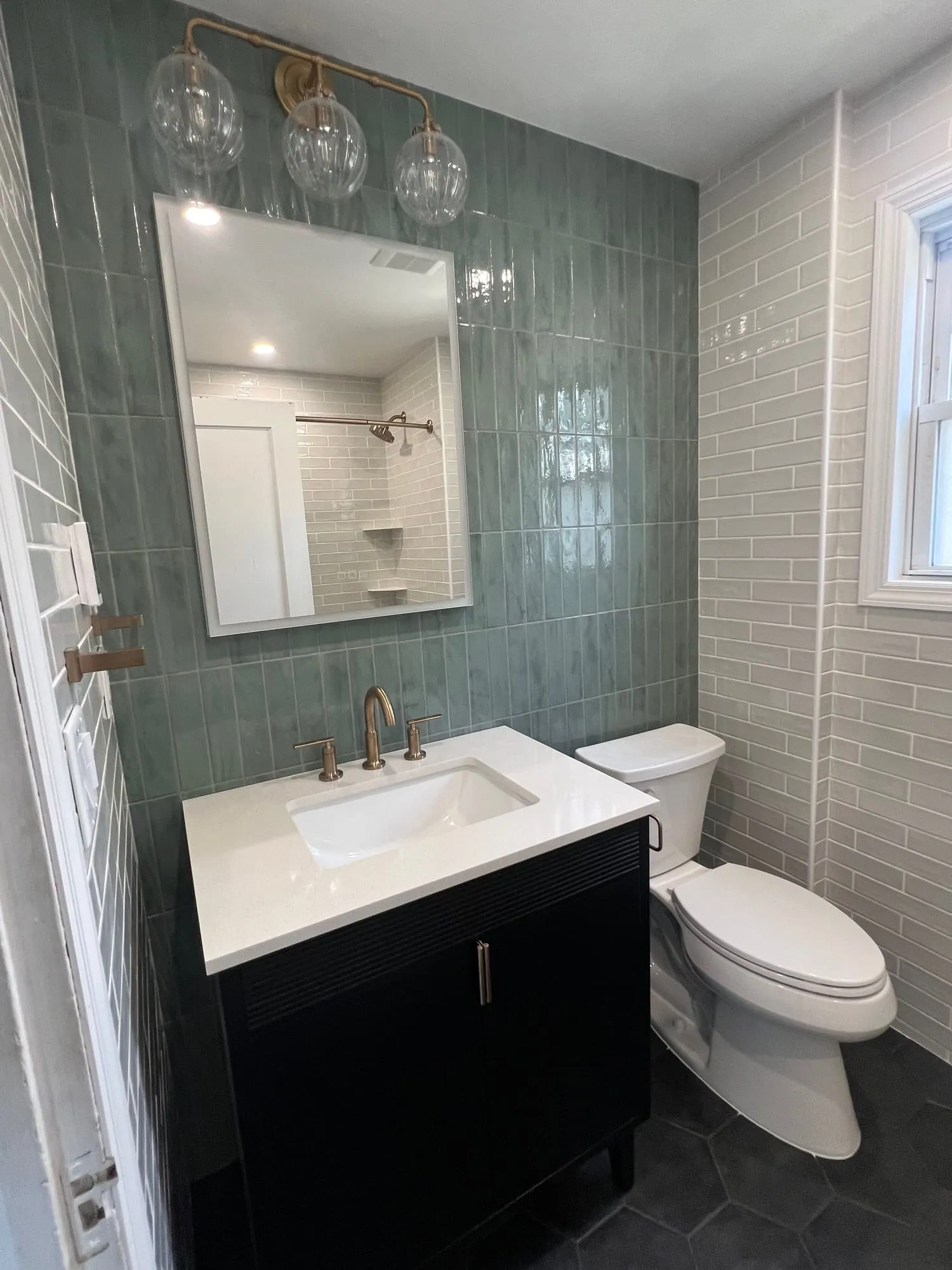 Black hexagon floor tile under a black vanity