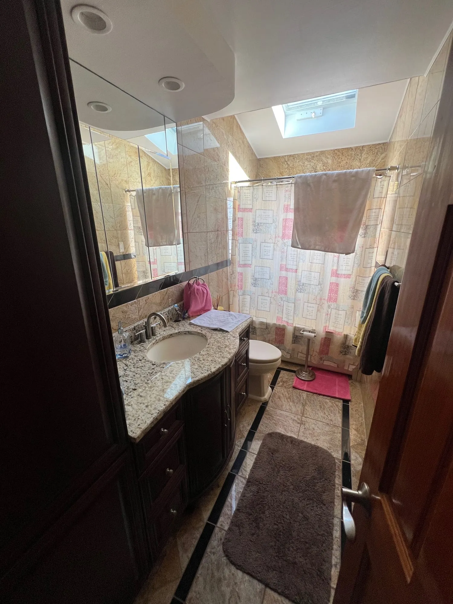Seaford bathroom before renovation, with a granite vanity and older finishes