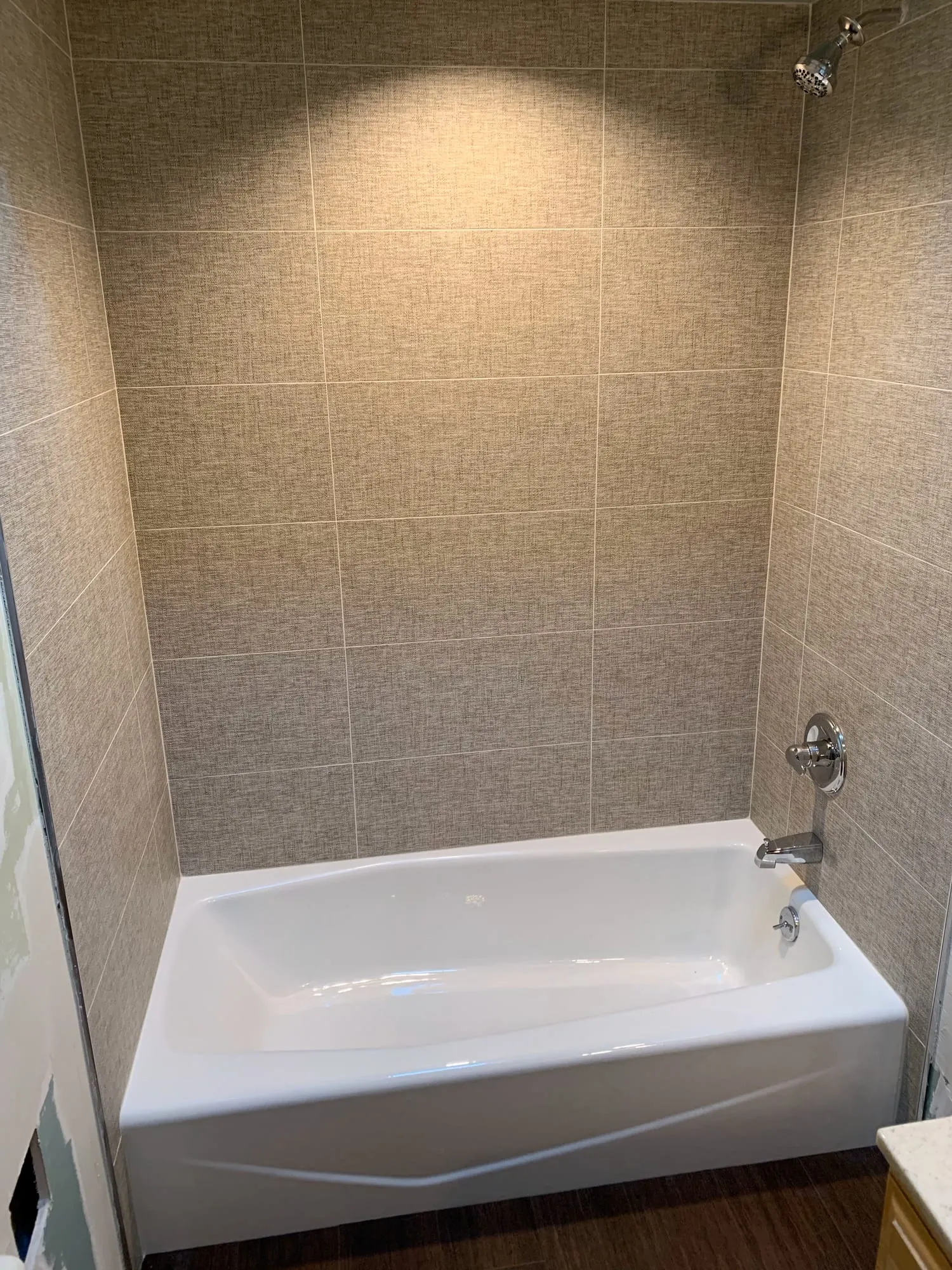New tub and tile surround with chrome fixtures